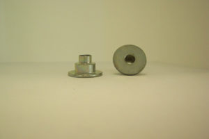 Cold formed shoulder rivet with drilled through hole used in the lawn and garden industry